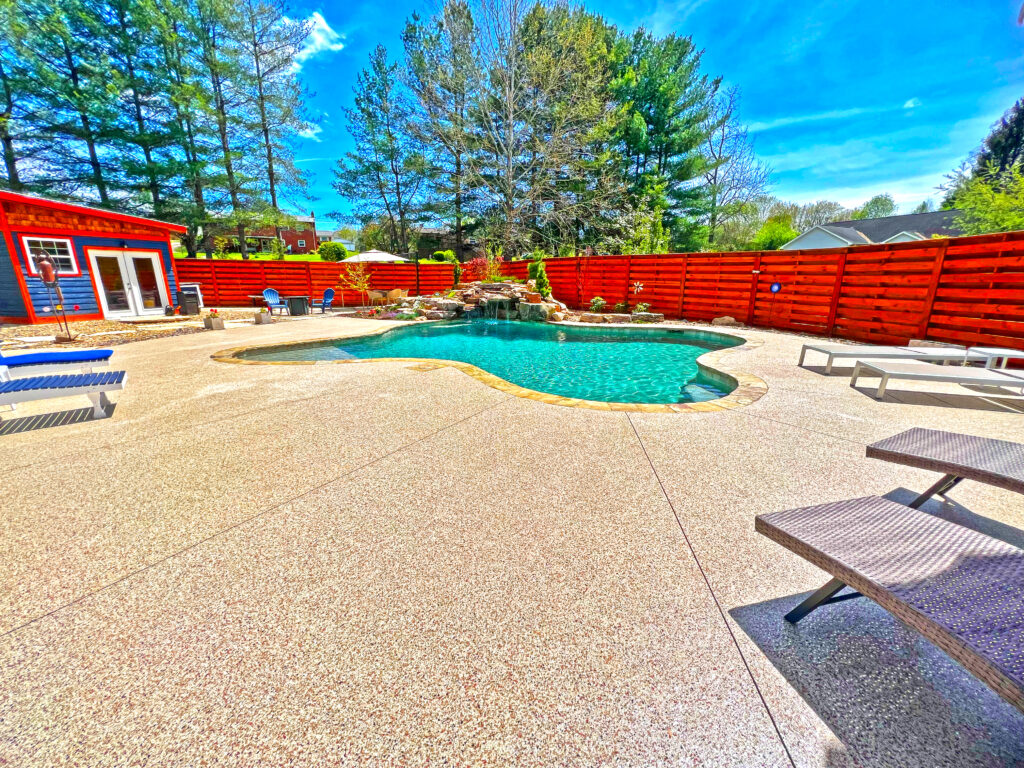 Light-colored decorative pool deck coating surrounding a residential swimming pool.