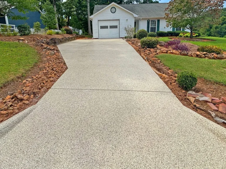 A house with a long driveway with a Shoreline color concrete coating by Atlas Coatings